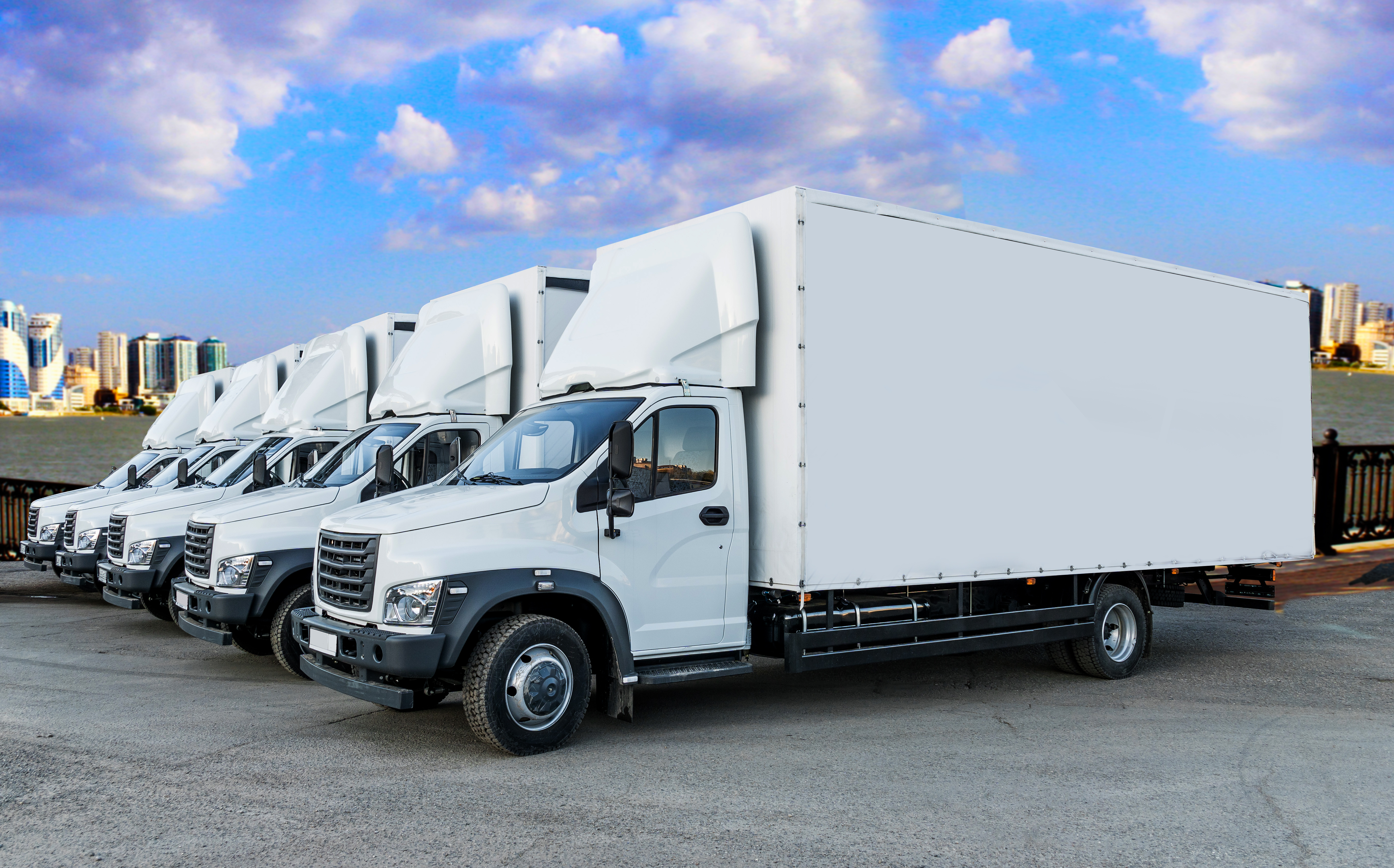 Five Box trucks that need insurance in a parking lot