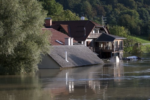House in flood with water up to the roof line